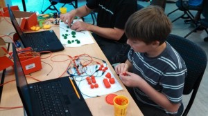 A student learns about circuitry by using tools in UMW's LearnerSpace