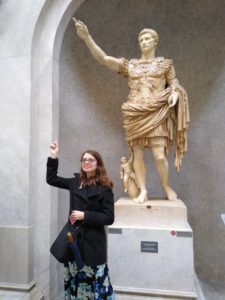 UMW senior Ruth Wilmot poses with the Primaporta Augustus statue, honoring the first emperor of the Roman Empire, during a study abroad trip to Rome prior to the pandemic. Mary Washington’s classics program just earned the top spot on a student-curated list in College Magazine.