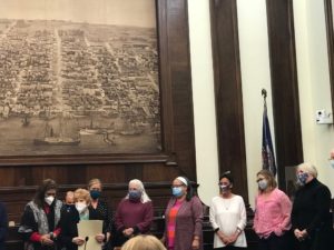 Members of the African American Heritage Trail Committee (including UMW Professor of History Krystyn Moon, far right, pink shirt) accept the Brenman Archaeology Award from the City of Alexandria.