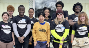 The UMW team poses with a new homeowner and Habitat for Humanity representatives in front of the house they helped build. (L-R: a Habitat for Humanity rep, Veda Salazar, Ian Frazier, Aloysious Kabonge, Chloe Jones, Paris Jones, the new homeowner, Walter Parks, Lindsey Coates-Crawford, Alton Guinn, Faye McKenzie, and Habitat Volunteer Coordinator April Elswick).