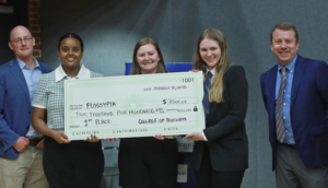 UMW seniors (L to R, middle of frame) Helen Worku, Taylor Munger and Katie Reif pose with judges for placing first in the Eagle Innovation StartUp Pitch Competition. Photo by Karen Pearlman.